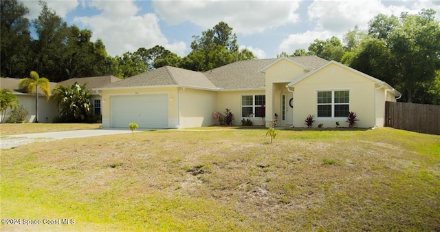 ranch-style home featuring a front yard and a garage