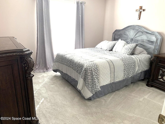 bedroom featuring light colored carpet