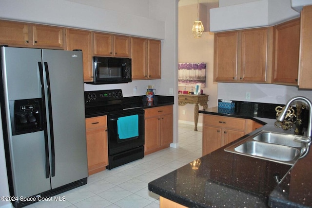 kitchen with pendant lighting, light tile patterned floors, sink, and black appliances