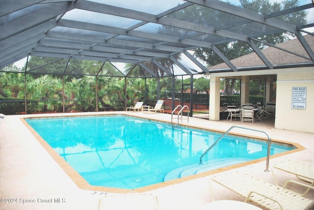 view of pool with a lanai and a patio area