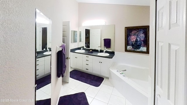 bathroom with vanity, a bathing tub, and tile patterned flooring