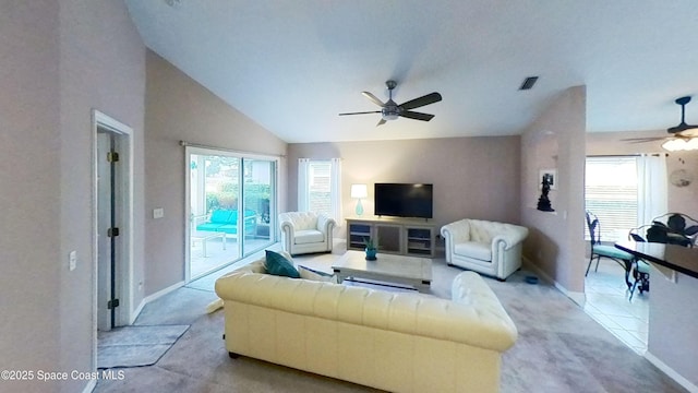 living room with lofted ceiling, ceiling fan, light colored carpet, and a healthy amount of sunlight