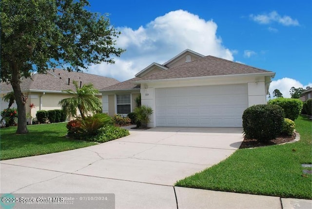 ranch-style home featuring a garage and a front yard