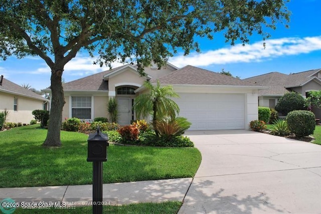 single story home featuring a garage and a front lawn