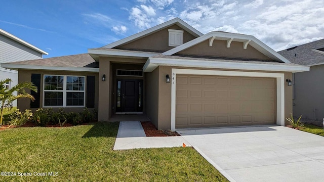 view of front of home with a garage and a front lawn