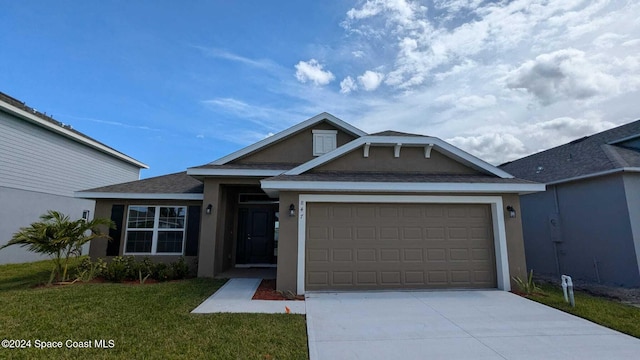 view of front of property featuring a garage and a front yard