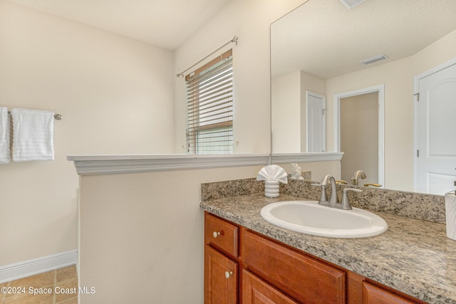 bathroom featuring tile patterned flooring and vanity