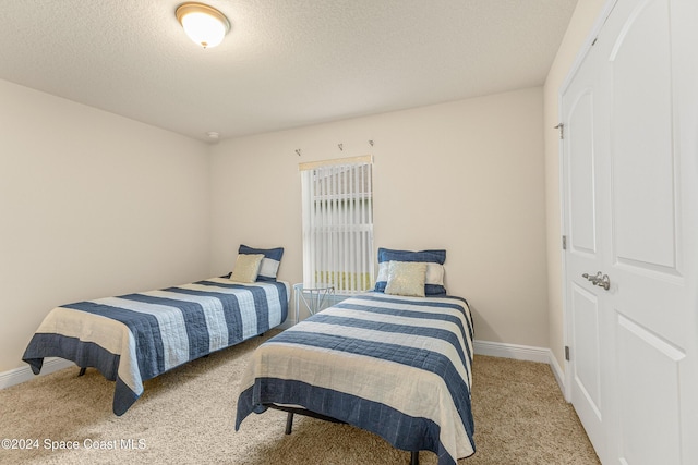 carpeted bedroom with a textured ceiling