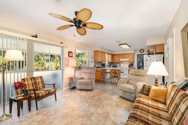 living room with light tile patterned flooring and ceiling fan