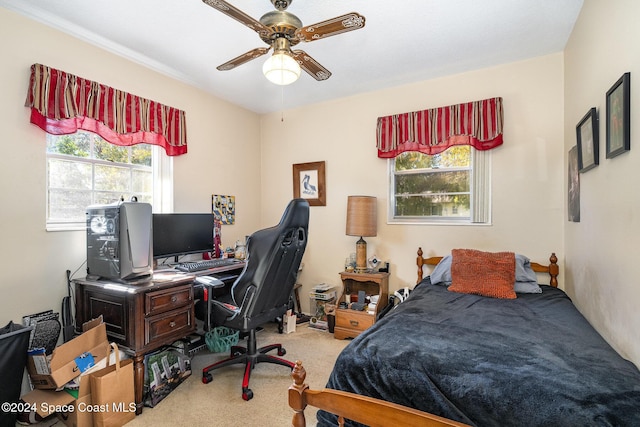 carpeted bedroom featuring multiple windows and ceiling fan