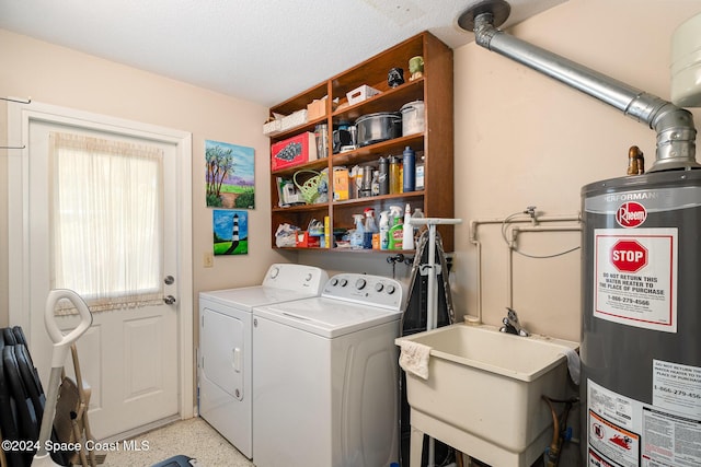 laundry room featuring gas water heater, sink, and washer and clothes dryer