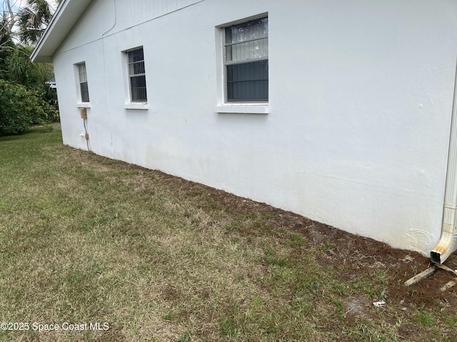 view of property exterior featuring a lawn