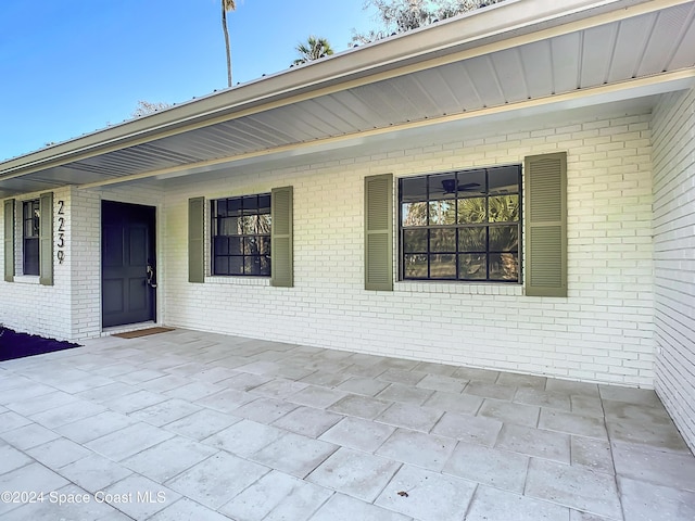 view of exterior entry with covered porch