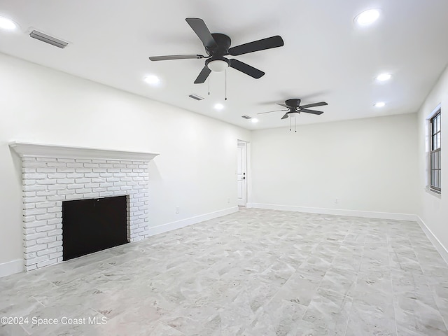 unfurnished living room with a fireplace and ceiling fan