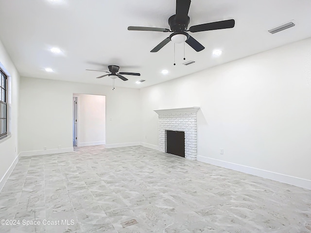 unfurnished living room with ceiling fan and a fireplace