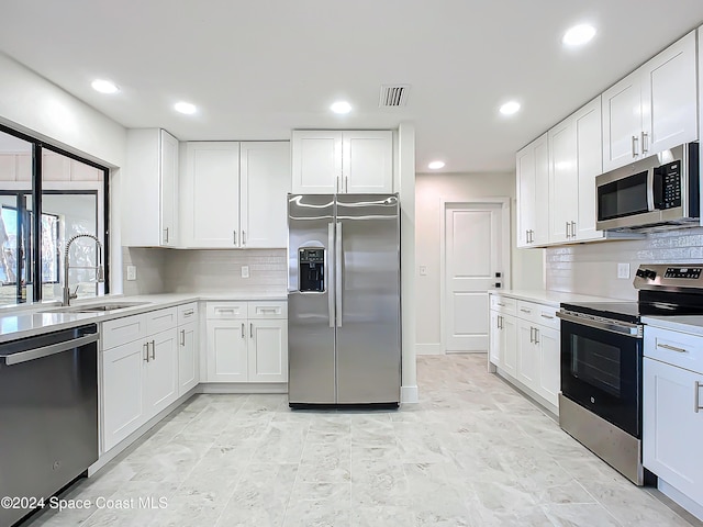 kitchen with white cabinetry and appliances with stainless steel finishes