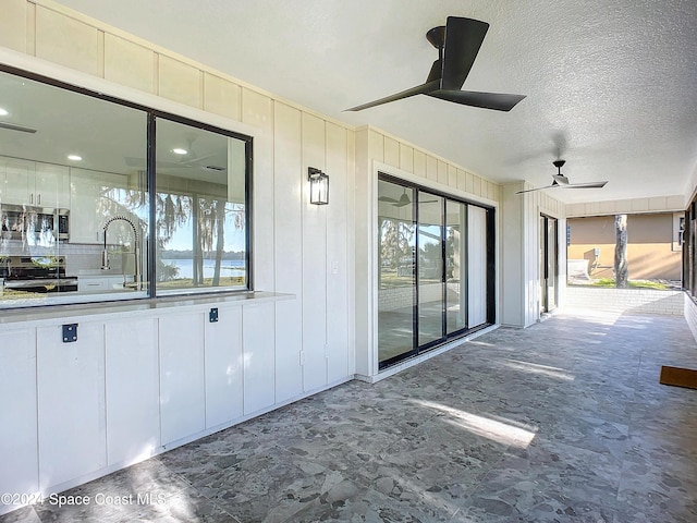 view of patio / terrace with ceiling fan and sink