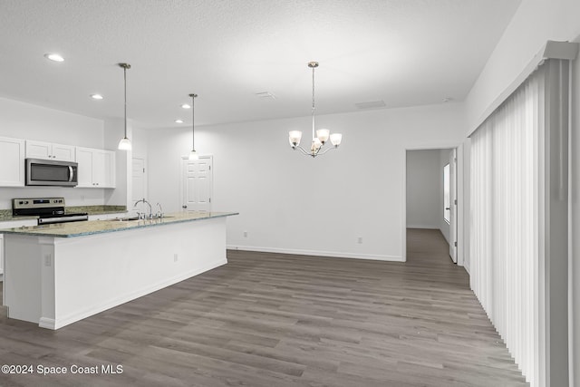 kitchen featuring pendant lighting, dark hardwood / wood-style flooring, white cabinetry, and stainless steel appliances