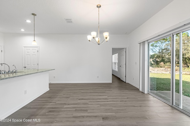 interior space with a chandelier, sink, and dark wood-type flooring