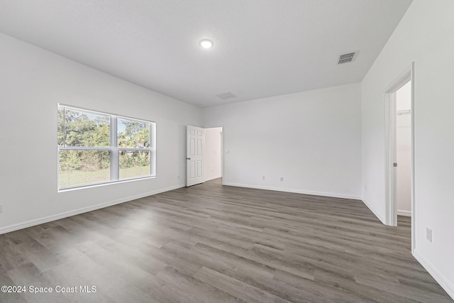 spare room with dark hardwood / wood-style floors