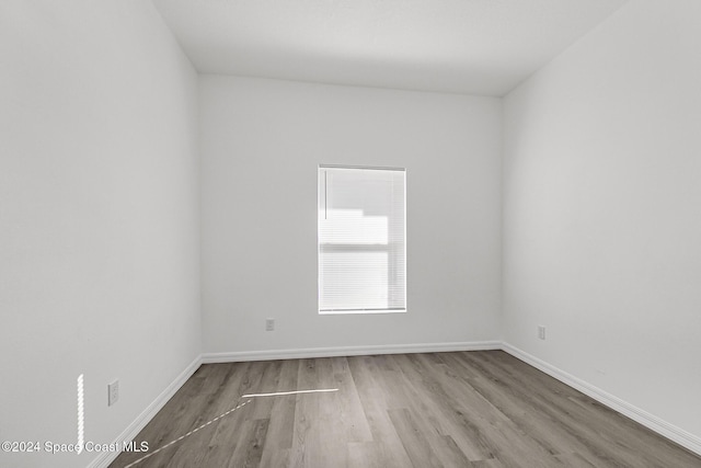 unfurnished room featuring hardwood / wood-style flooring