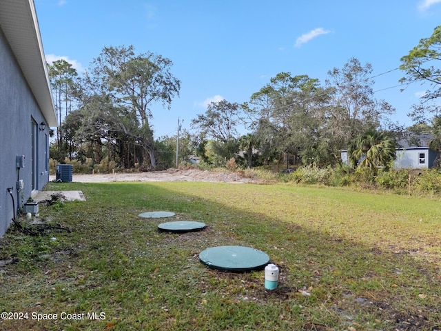 view of yard with central AC