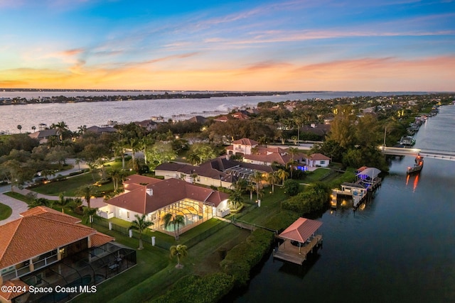 aerial view at dusk with a water view