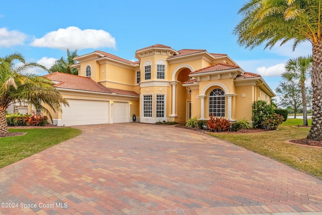 mediterranean / spanish-style home featuring a front lawn