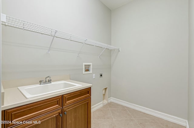 laundry room featuring cabinets, sink, hookup for a washing machine, light tile patterned floors, and hookup for an electric dryer