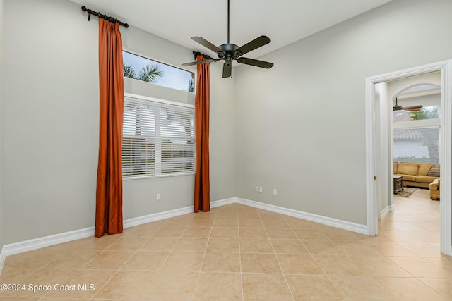 tiled empty room with ceiling fan