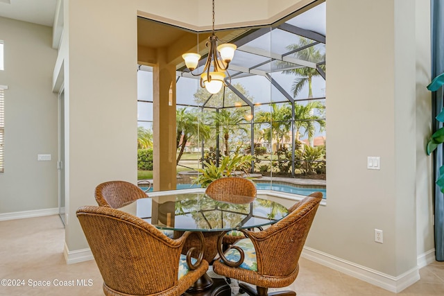 tiled dining area featuring a healthy amount of sunlight and an inviting chandelier