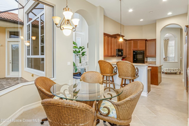 tiled dining room featuring an inviting chandelier