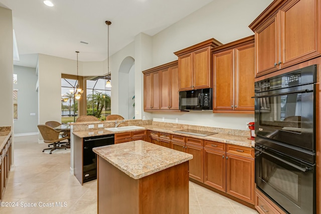 kitchen with an inviting chandelier, black appliances, light stone countertops, decorative light fixtures, and kitchen peninsula