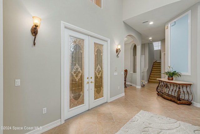 foyer entrance featuring french doors and light tile patterned floors