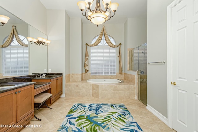 bathroom with tile patterned floors, vanity, separate shower and tub, and an inviting chandelier