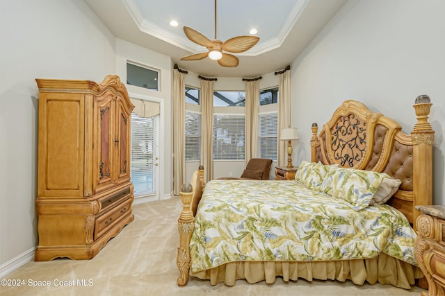 bedroom featuring ceiling fan, crown molding, a tray ceiling, light colored carpet, and access to outside