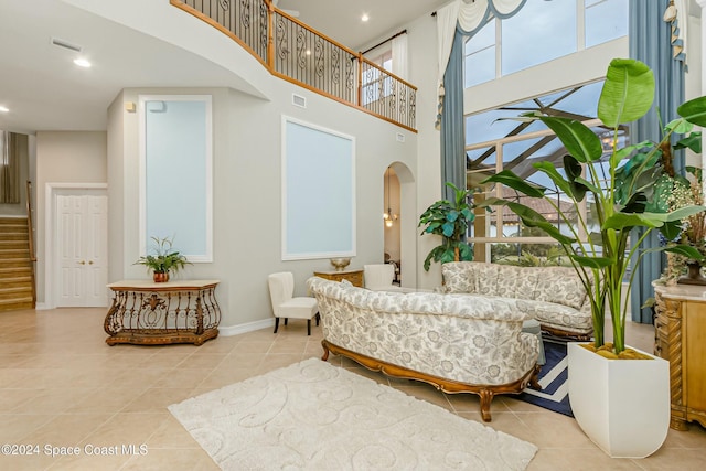 interior space featuring a high ceiling and light tile patterned floors