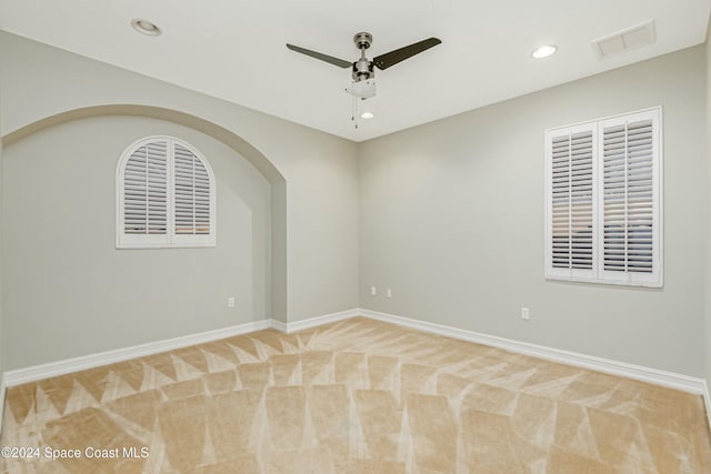 carpeted spare room with ceiling fan