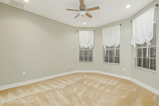 spare room featuring carpet and ceiling fan