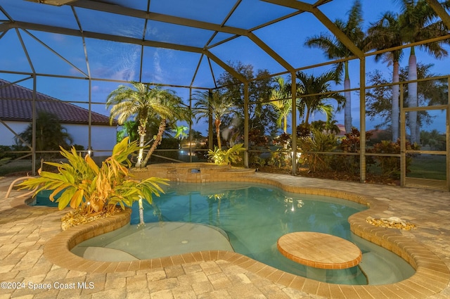 view of swimming pool featuring a lanai and a patio