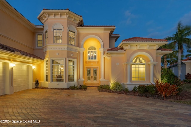 view of front facade featuring a garage and french doors