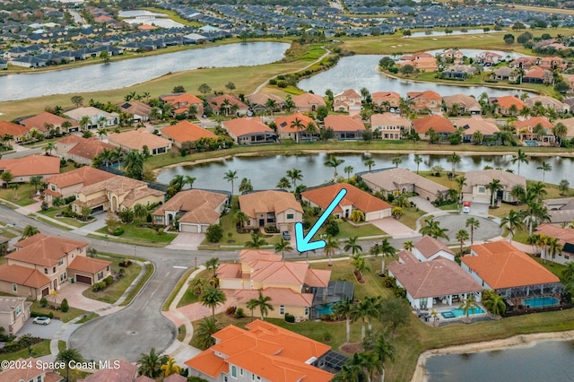 birds eye view of property featuring a water view