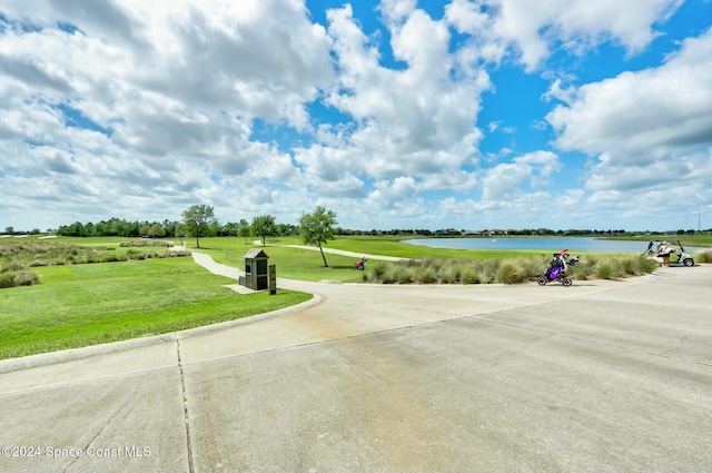 view of community featuring a yard and a water view