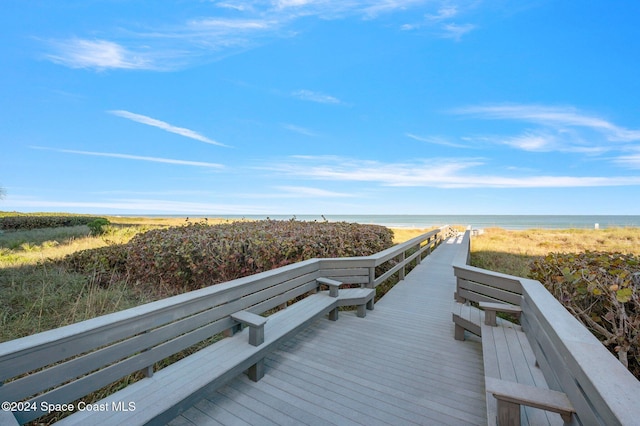 view of home's community with a view of the beach and a deck with water view