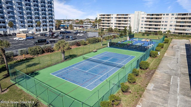 view of sport court featuring fence