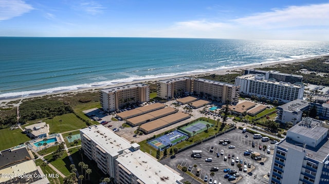 drone / aerial view featuring a water view and a beach view