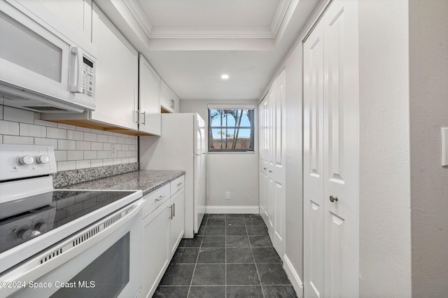 kitchen featuring light stone countertops, white appliances, decorative backsplash, white cabinets, and ornamental molding