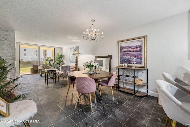 dining area with a textured ceiling and a chandelier