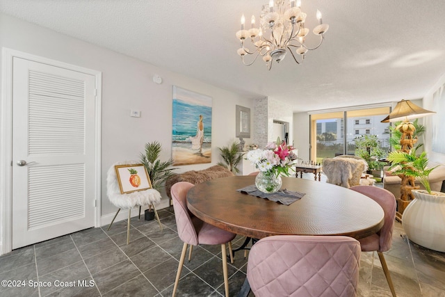 dining area featuring a chandelier and a textured ceiling