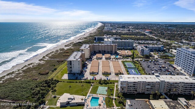 aerial view featuring a water view, a view of city, and a beach view